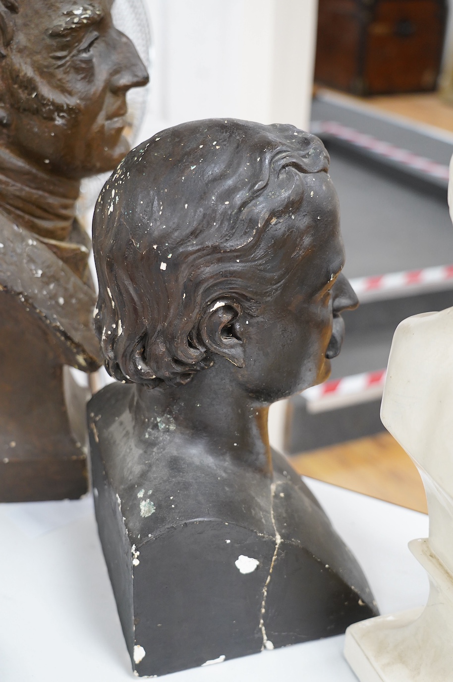 Three decorative plaster busts; the Duke of Wellington, 60cm high, another male figure, and a child. Condition - poor